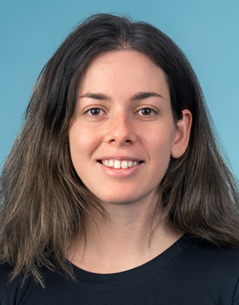 Smiling young woman headshot on blue background